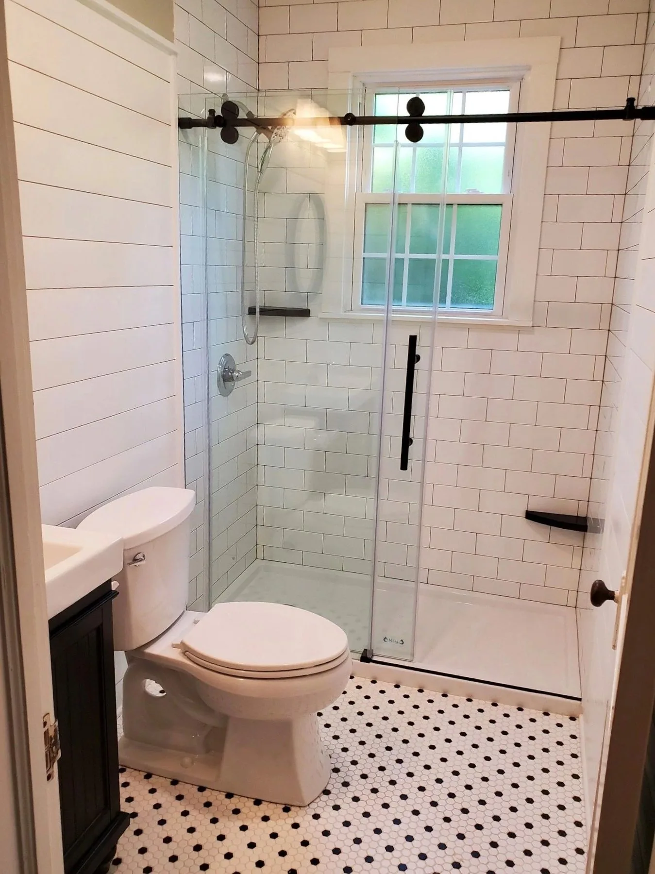 Bathroom with white subway tile shower and hex mosaic floor