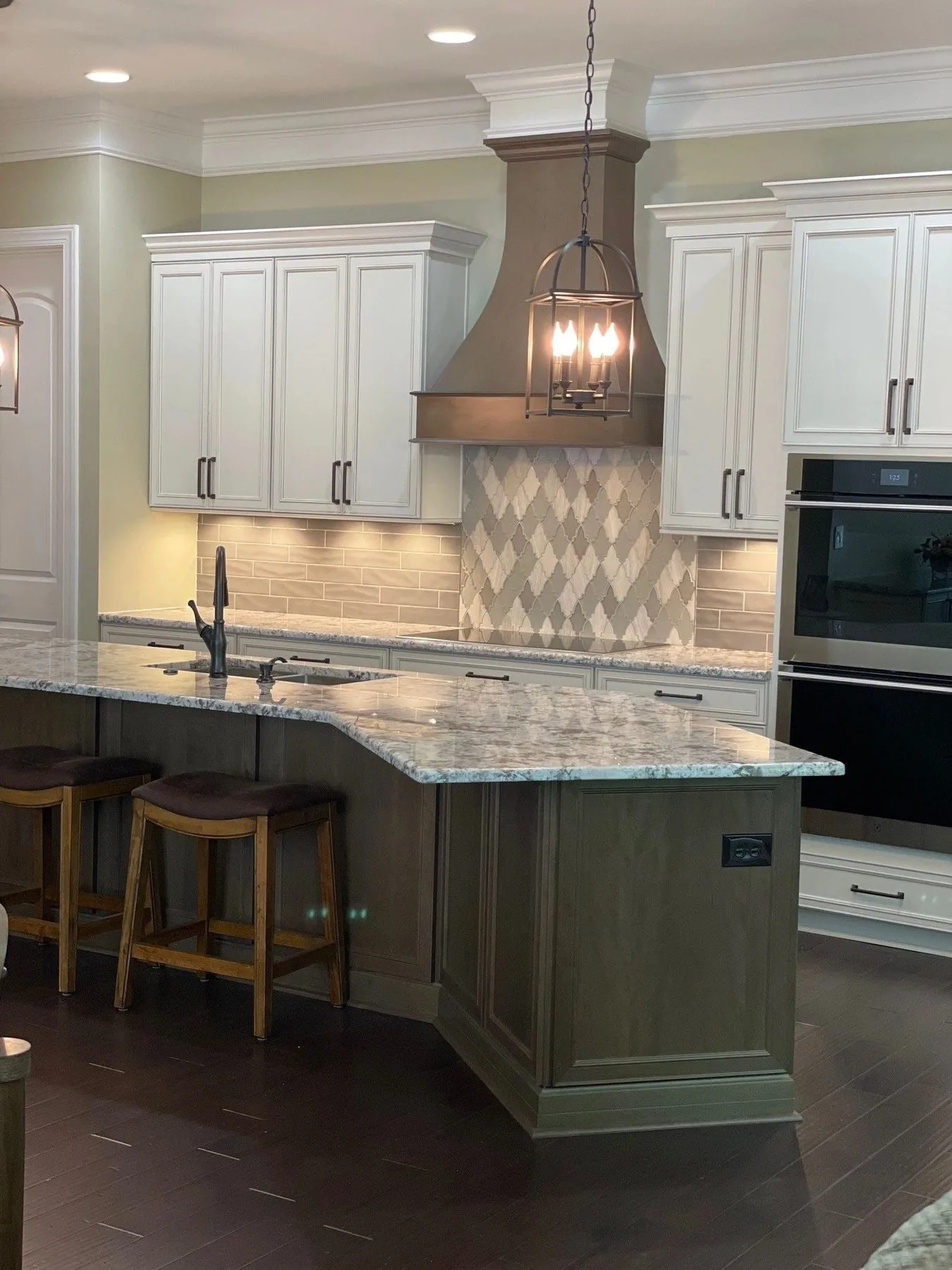 Kitchen by Queen City Kitchen and Bath with white cabinetry, granite countertops, and lantern pendants