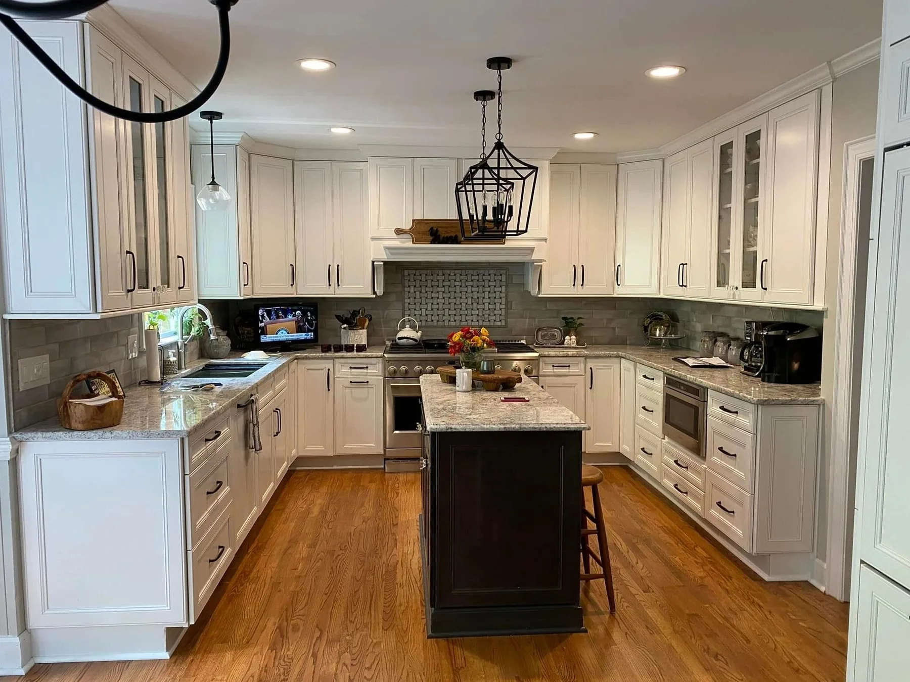 White kitchen with dark island and basketweave tile detail